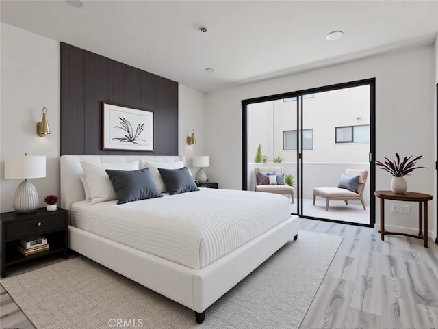 bedroom featuring light wood-type flooring and access to exterior