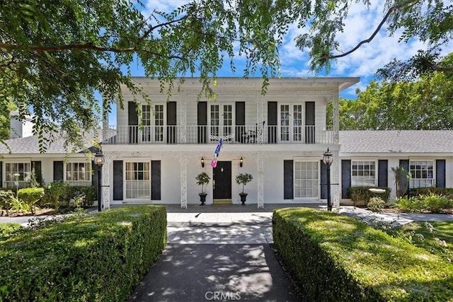 2141 Westminster Dr, Riverside, CA 92506 - view of front of home with a balcony, french doors, and covered porch