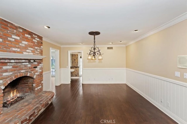 2141 Westminster Dr, Riverside, CA 92506 - unfurnished living room featuring wainscoting, dark wood-style floors, a chandelier, a fireplace, and ornamental molding
