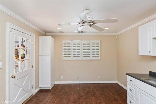 2141 Westminster Dr, Riverside, CA 92506 - kitchen featuring dark wood finished floors, dark countertops, white cabinetry, crown molding, and a ceiling fan