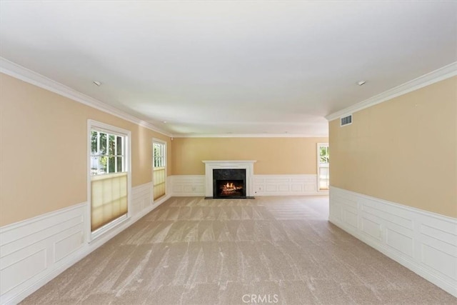 2141 Westminster Dr, Riverside, CA 92506 - unfurnished living room with crown molding, a fireplace with flush hearth, wainscoting, plenty of natural light, and light carpet