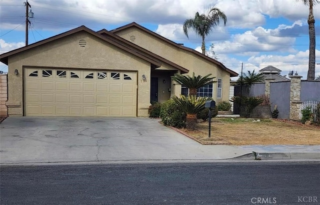 725 18th Pl, Delano, CA 93215 - ranch-style house featuring stucco siding, driveway, and a garage