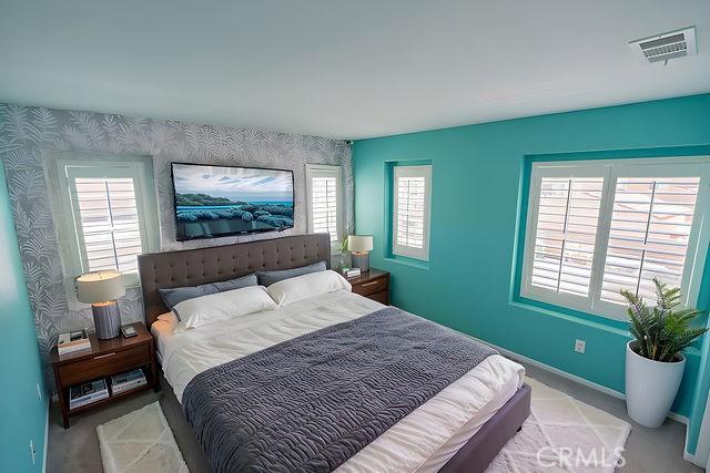 24189 Darmera Dr, Lake Elsinore, CA 92532 - carpeted bedroom with baseboards, wallpapered walls, and an accent wall