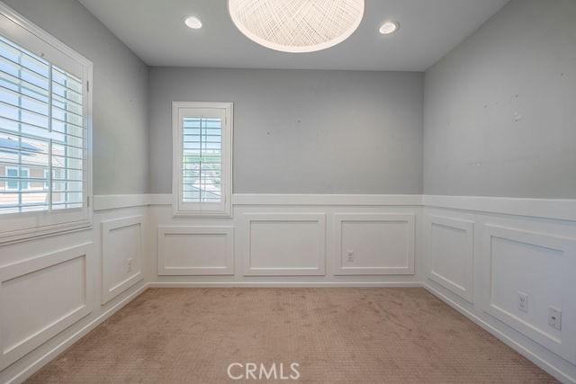 24189 Darmera Dr, Lake Elsinore, CA 92532 - unfurnished room with a decorative wall, light carpet, a wainscoted wall, and recessed lighting