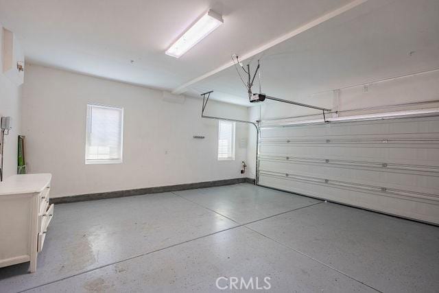 24189 Darmera Dr, Lake Elsinore, CA 92532 - garage with a garage door opener and baseboards