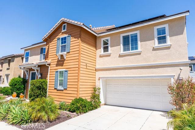 24189 Darmera Dr, Lake Elsinore, CA 92532 - traditional-style house with concrete driveway, a garage, and stucco siding