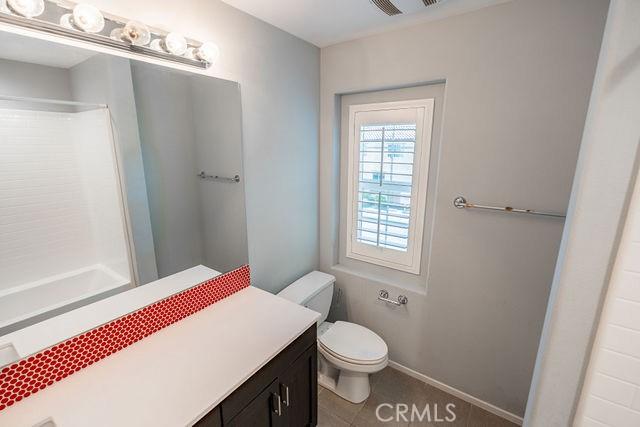 24189 Darmera Dr, Lake Elsinore, CA 92532 - bathroom with toilet, vanity, and a shower