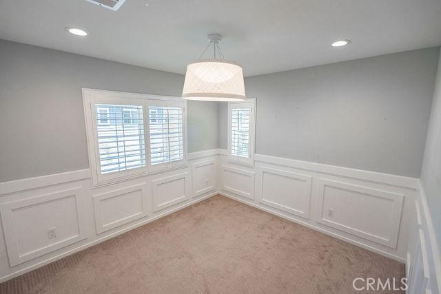 24189 Darmera Dr, Lake Elsinore, CA 92532 - unfurnished dining area with a decorative wall, a wainscoted wall, light colored carpet, and recessed lighting