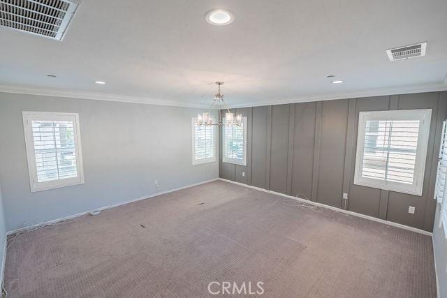 24189 Darmera Dr, Lake Elsinore, CA 92532 - empty room with ornamental molding, a chandelier, carpet flooring, healthy amount of natural light, and recessed lighting