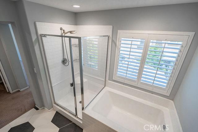 24189 Darmera Dr, Lake Elsinore, CA 92532 - full bath featuring a stall shower, healthy amount of natural light, a bath, tile patterned flooring, and recessed lighting