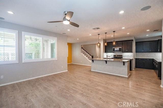 24189 Darmera Dr, Lake Elsinore, CA 92532 - kitchen featuring appliances with stainless steel finishes, a ceiling fan, light wood finished floors, and recessed lighting