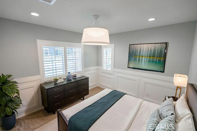 24189 Darmera Dr, Lake Elsinore, CA 92532 - bedroom with a decorative wall, a wainscoted wall, recessed lighting, and light colored carpet