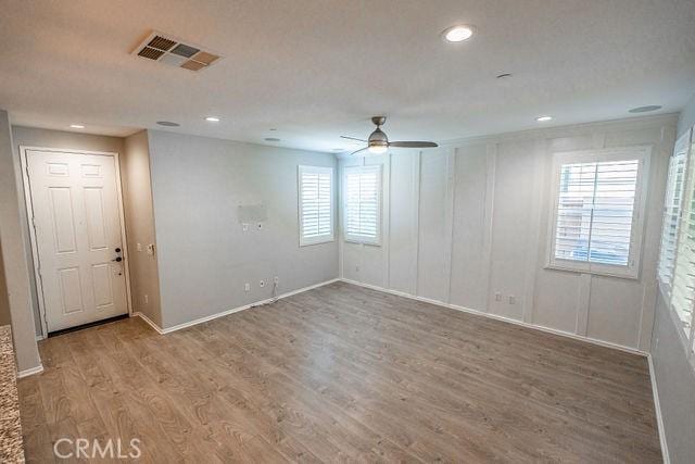 24189 Darmera Dr, Lake Elsinore, CA 92532 - empty room with ceiling fan, wood finished floors, baseboards, and recessed lighting