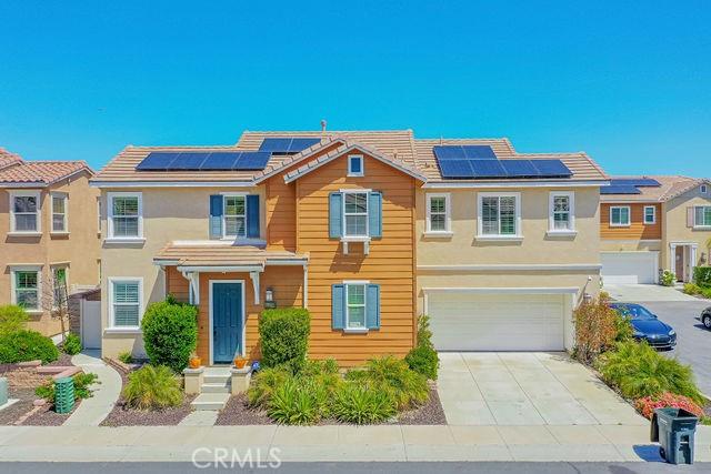 24189 Darmera Dr, Lake Elsinore, CA 92532 - view of front of property featuring concrete driveway, an attached garage, solar panels, and stucco siding