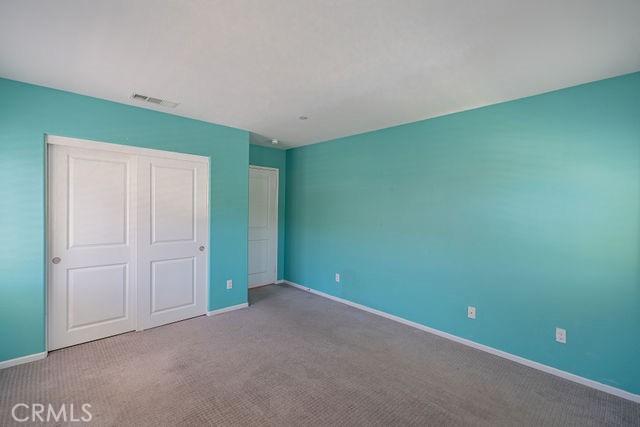 24189 Darmera Dr, Lake Elsinore, CA 92532 - unfurnished bedroom with carpet floors, baseboards, and a closet
