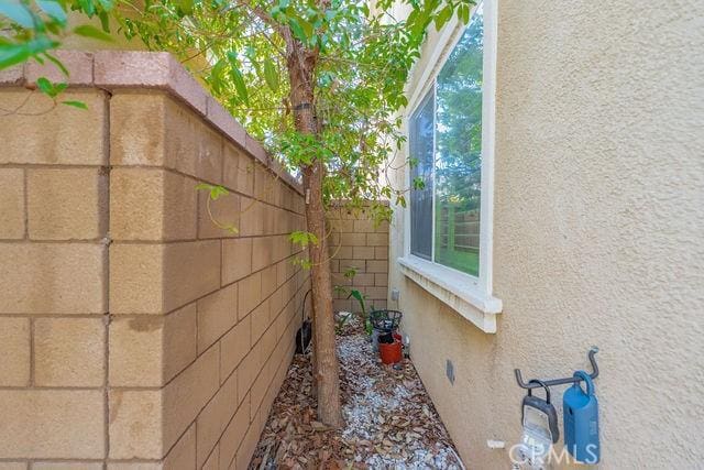 24189 Darmera Dr, Lake Elsinore, CA 92532 - view of side of property with fence and stucco siding