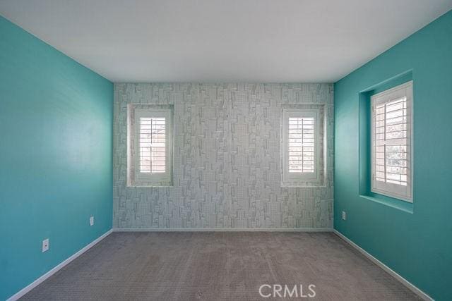 24189 Darmera Dr, Lake Elsinore, CA 92532 - unfurnished room featuring plenty of natural light, baseboards, and carpet