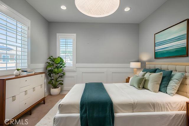 24189 Darmera Dr, Lake Elsinore, CA 92532 - bedroom with multiple windows, a wainscoted wall, and recessed lighting