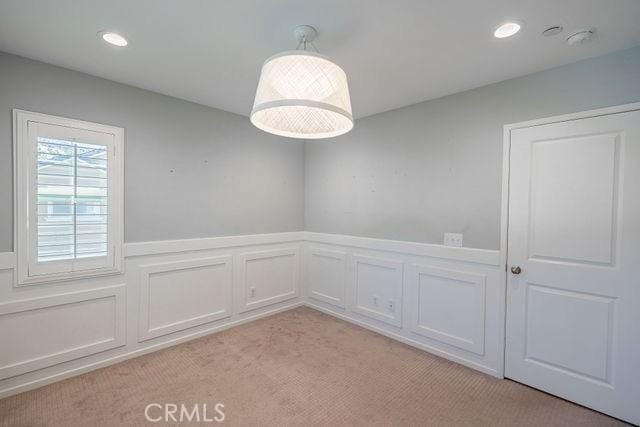 24189 Darmera Dr, Lake Elsinore, CA 92532 - unfurnished room featuring light carpet, wainscoting, a decorative wall, and recessed lighting