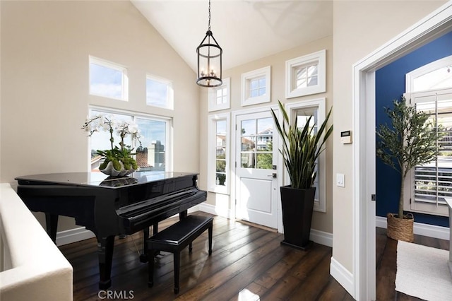 entrance foyer with baseboards, dark wood finished floors, and high vaulted ceiling