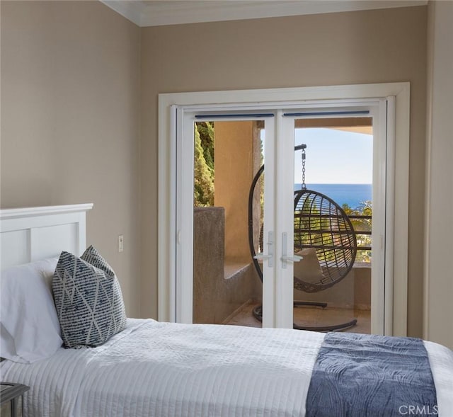 bedroom featuring crown molding, a water view, french doors, and access to exterior