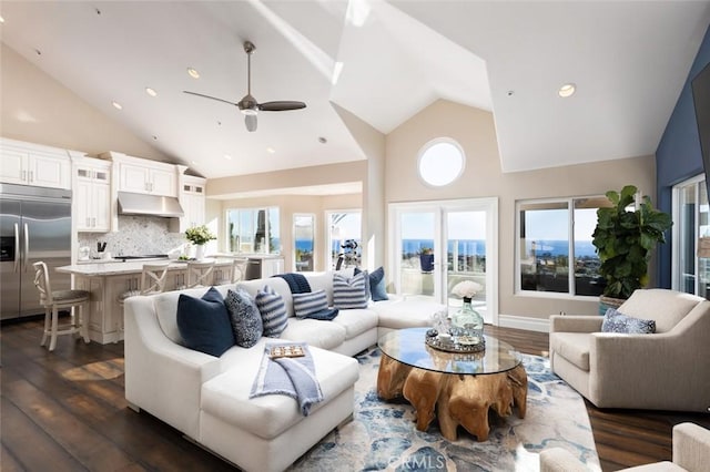 living area with high vaulted ceiling, a ceiling fan, and dark wood finished floors