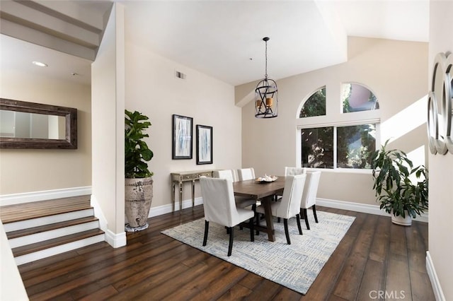 dining space featuring visible vents, dark wood-style flooring, and baseboards