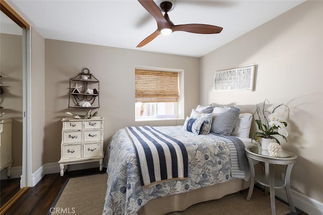bedroom featuring baseboards, a ceiling fan, and dark wood finished floors