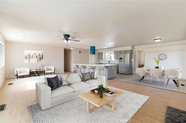 2738 S Fairway Ct, Visalia, CA 93277 - living room featuring a ceiling fan, light wood-style flooring, and visible vents