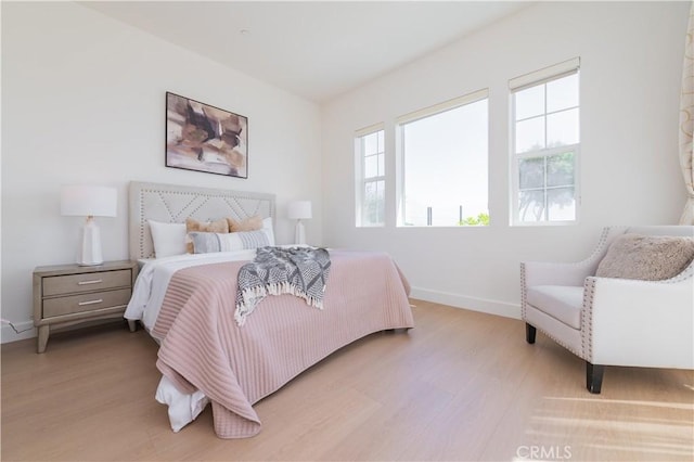 bedroom with baseboards and wood finished floors