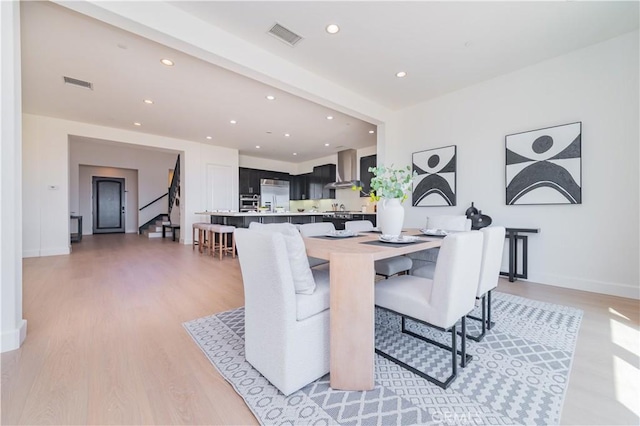 dining area with stairs, visible vents, recessed lighting, light wood-style flooring, and baseboards