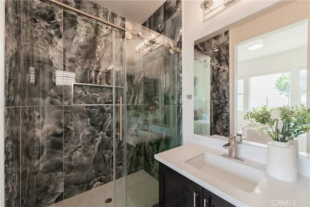bathroom with a stall shower and vanity
