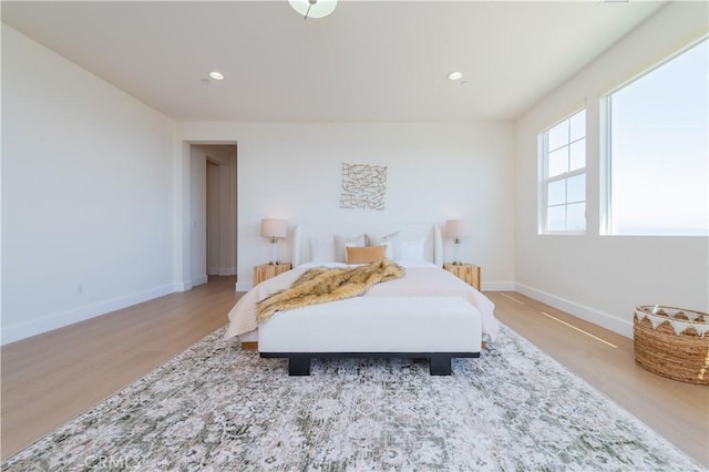 bedroom featuring baseboards, light wood-style floors, and recessed lighting