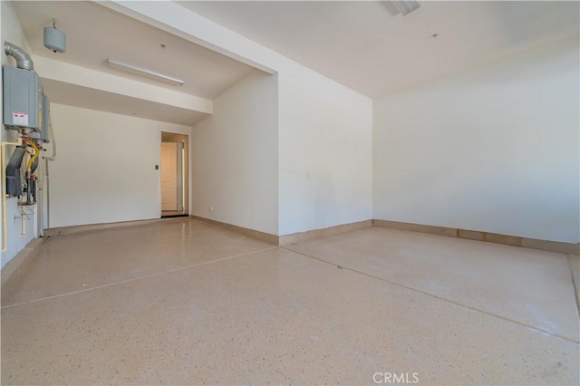 garage with baseboards and water heater