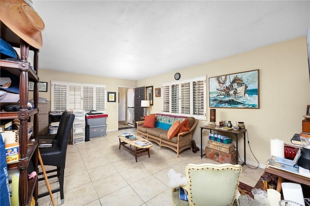 tiled living area featuring baseboards