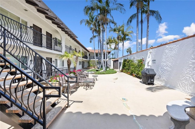 view of home's community featuring a patio area and stairway