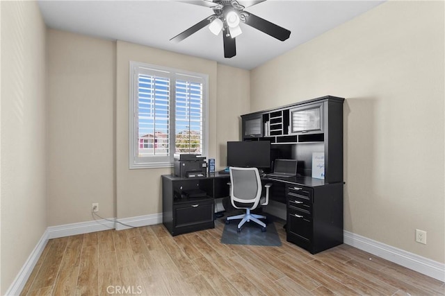 office area featuring light wood-style flooring, baseboards, and a ceiling fan