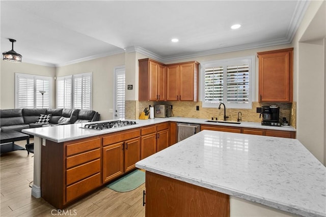 kitchen with a healthy amount of sunlight, stainless steel appliances, open floor plan, and a sink