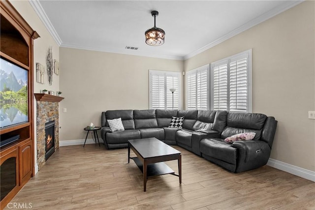 living area featuring a fireplace, light wood finished floors, baseboards, and visible vents