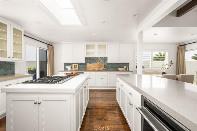 32491 Seven Seas Dr, Dana Point, CA 92629 - kitchen featuring dark wood-style flooring, white cabinetry, decorative backsplash, and stainless steel gas cooktop
