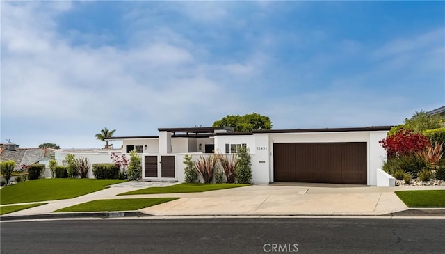 32491 Seven Seas Dr, Dana Point, CA 92629 - contemporary house featuring a garage, stucco siding, and concrete driveway