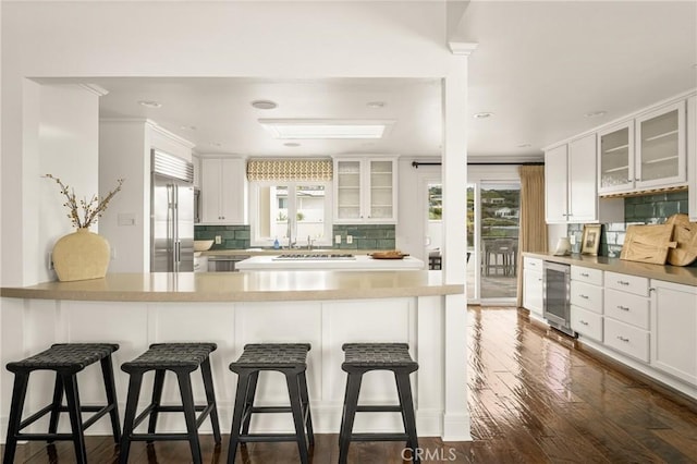 32491 Seven Seas Dr, Dana Point, CA 92629 - kitchen featuring built in refrigerator, backsplash, wine cooler, and glass insert cabinets