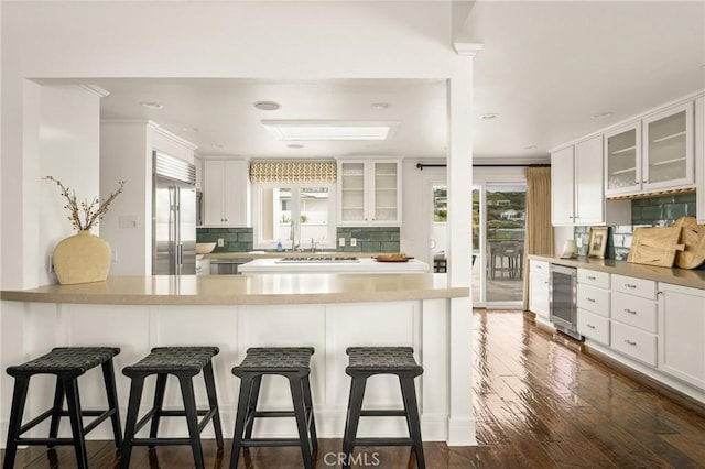 32491 Seven Seas Dr, Dana Point, CA 92629 - kitchen featuring built in refrigerator, beverage cooler, tasteful backsplash, glass insert cabinets, and white cabinetry