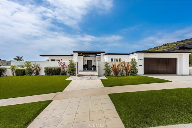 32491 Seven Seas Dr, Dana Point, CA 92629 - modern home with concrete driveway, stucco siding, and a front yard