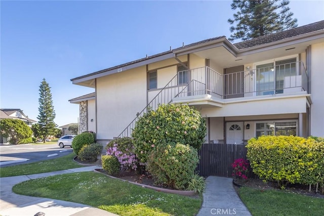 23026 Nadine Cir Unit B, Torrance, CA 90505 - view of front of property with stucco siding, fence, and a balcony