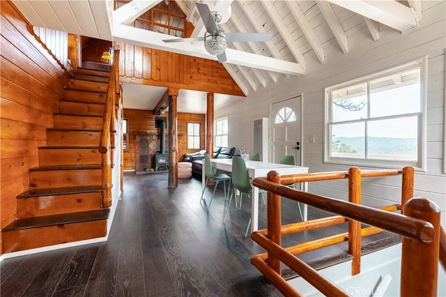 356 Wylerhorn Dr, Crestline, CA 92325 - stairs featuring a wood stove, a wealth of natural light, beam ceiling, and hardwood / wood-style floors