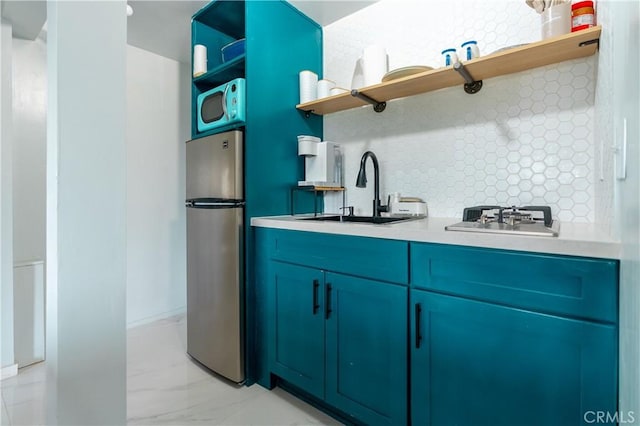 356 Wylerhorn Dr, Crestline, CA 92325 - kitchen with a sink, open shelves, decorative backsplash, light countertops, and appliances with stainless steel finishes