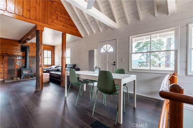 356 Wylerhorn Dr, Crestline, CA 92325 - dining space with a wood stove, wooden walls, a wealth of natural light, and dark wood finished floors