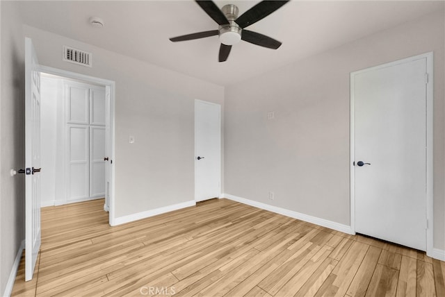 unfurnished bedroom with baseboards, ceiling fan, light wood-style floors, and visible vents