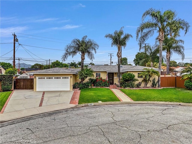 single story home with concrete driveway, stucco siding, a front lawn, and fence